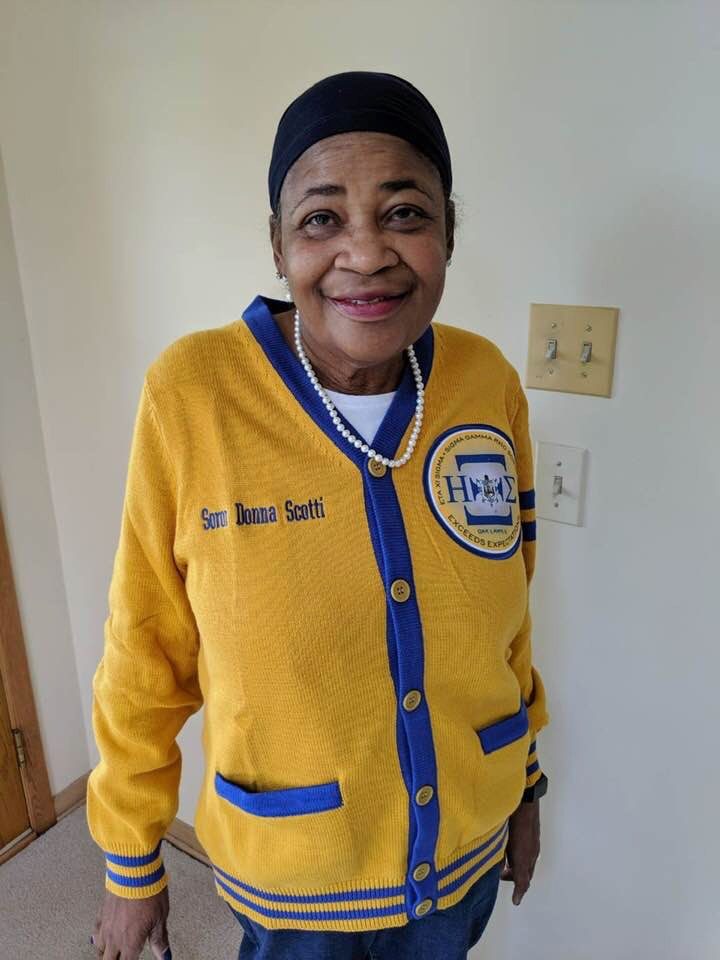 Donna Jean wearing her Sigma Gamma Rho cardigan embroidered Soror Donna Scotti