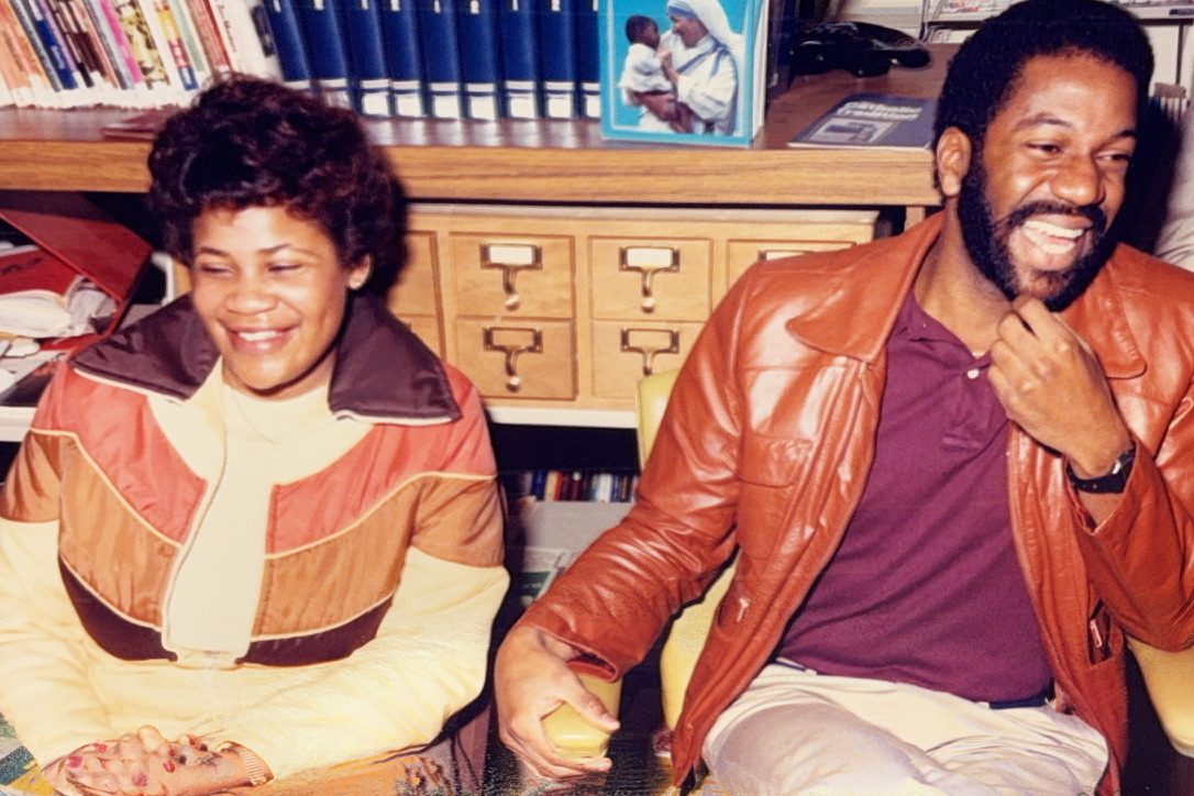 Donna Jean and her husband seated together, both laughing