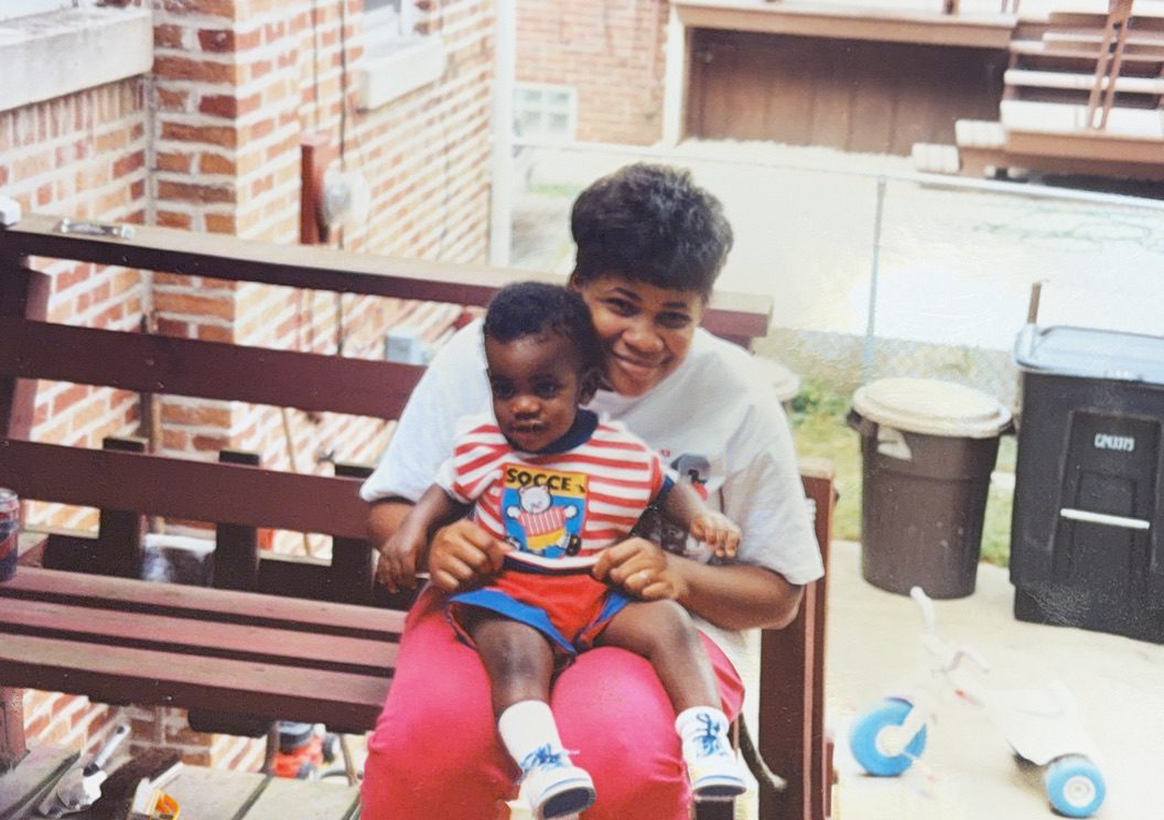 Donna Jean holding her son as a toddler on a back porch