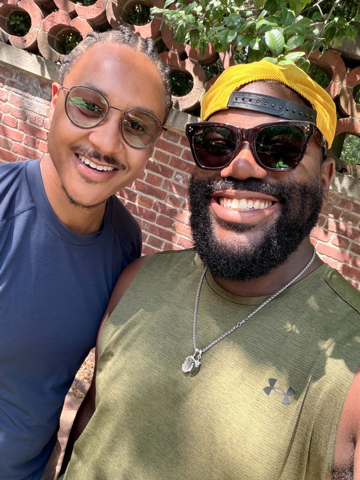Victor and his friend Aaron in front of a brick wall