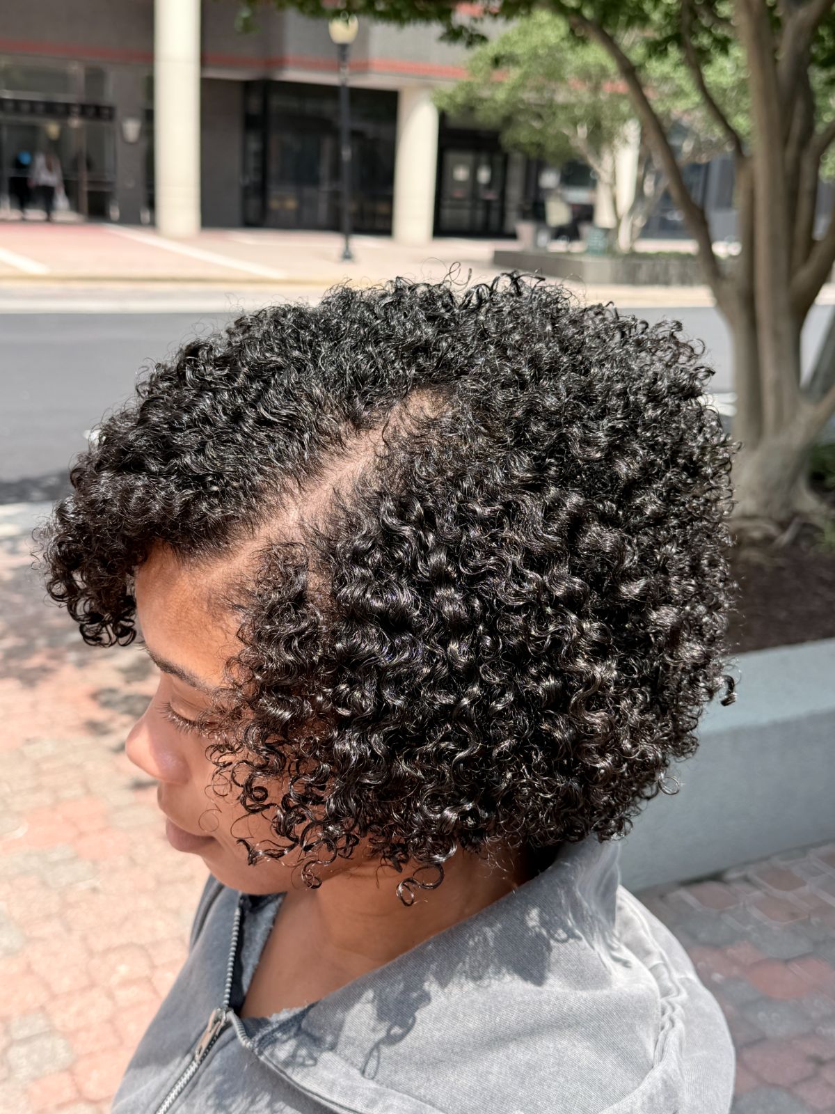 A guest’s natural curl pattern, cut and shaped